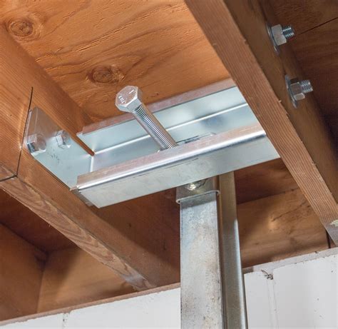 metal bracket for beam wall addition|secure basement wall to steel beam.